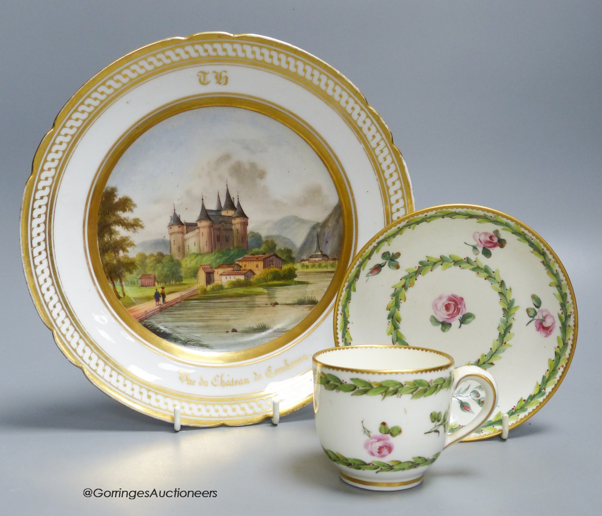 A Sevres porcelain coffee cup and saucer painted with flowers and chains of husks, and a paris porcelain plate with titled scene and initials TH